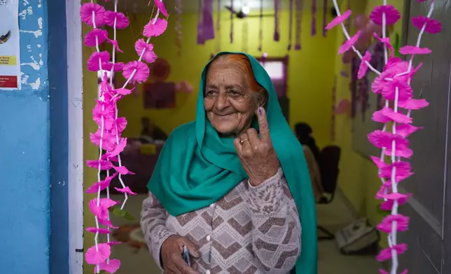 An elderly woman shows the indelible ink mark on her finger after casting vote at women only booth during the first round of polling of India’s national election in Doda district, Jammu and Kashmir, India, Friday, April 19, 2024. (AP Photo/Channi Anand)