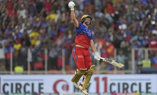 Royal Challengers Bengaluru's Will Jacks celebrates his century during the Indian Premier League cricket match between Gujarat Titans and Royal Challengers Bengaluru in Ahmedabad, India, Sunday, April 28, 2024. (AP Photo /Ajit Solanki)