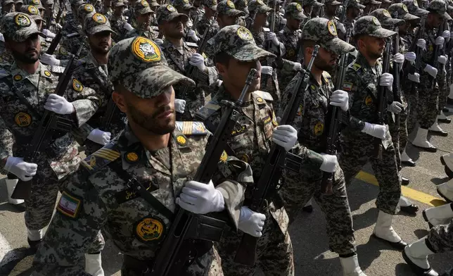 Iranian army members march during Army Day parade at a military base in northern Tehran, Iran, Wednesday, April 17, 2024. In the parade, President Ebrahim Raisi warned that the "tiniest invasion" by Israel would bring a "massive and harsh" response, as the region braces for potential Israeli retaliation after Iran's attack over the weekend. (AP Photo/Vahid Salemi)