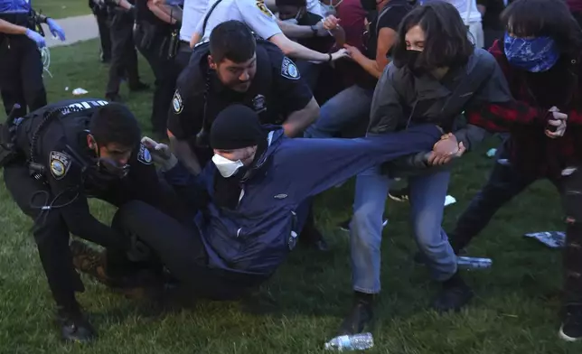 Police arrest protesters attempting to camp in support of Palestinians on Washington University's campus in St. Louis, Saturday, April 27, 2024. (Christine Tannous/St. Louis Post-Dispatch via AP)