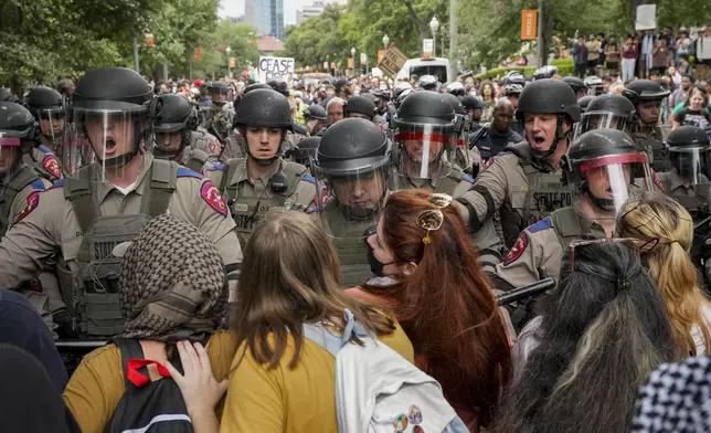Texas state troopers in riot gear try to break up a pro-Palestinian protest at the University of Texas, Wednesday, April 24, 2024, in Austin, Texas. (Jay Janner/Austin American-Statesman via AP)