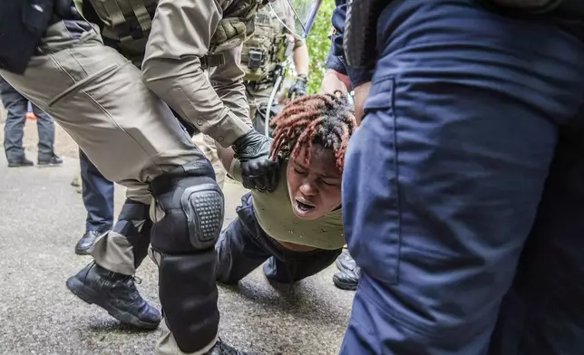 A demonstrator is restrained by police at a pro-Palestinian protest at the University of Texas, Wednesday, April 24, 2024, in Austin, Texas. (Ricardo B. Brazziell/Austin American-Statesman via AP)