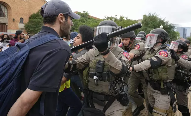 Texas state troopers in riot gear try to break up a pro-Palestinian protest at the University of Texas, Wednesday, April 24, 2024, in Austin, Texas. (Jay Janner/Austin American-Statesman via AP)