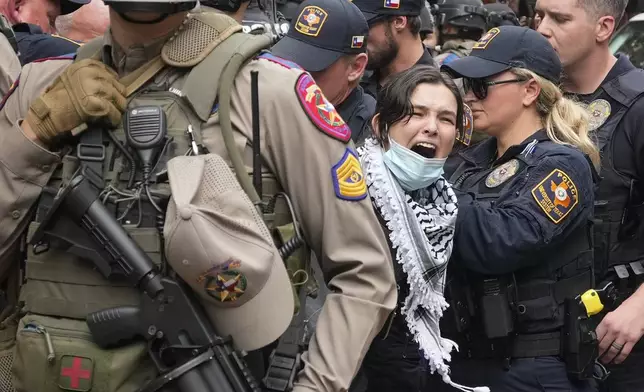A woman is arrested at a pro-Palestinian protest at the University of Texas, Wednesday, April 24, 2024, in Austin. (Jay Janner/Austin American-Statesman via AP)