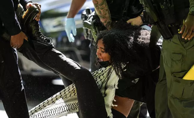 Authorities detain a protester on the campus of Emory University during a pro-Palestinian demonstration, Thursday, April 25, 2024, in Atlanta. (AP Photo/Mike Stewart)