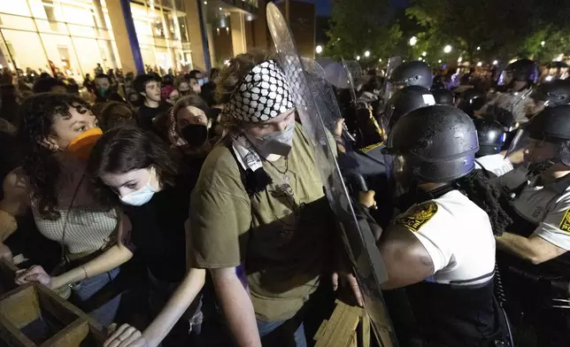 Demonstrators and law enforcement officers clash during a pro-Palestinian rally at Virginia Commonwealth University, Monday, April 29, 2024, in Richmond, Va. (Mike Kropf/Richmond Times-Dispatch via AP)
