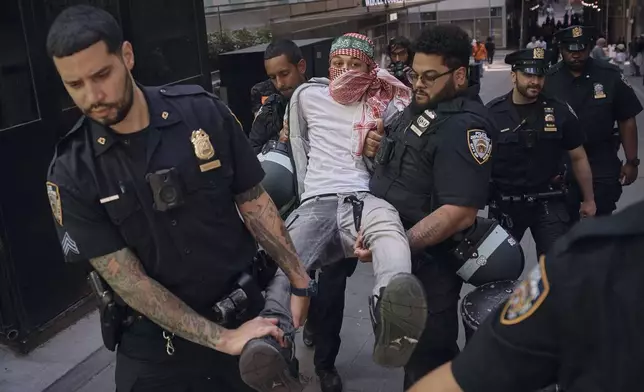 Police arrest a protester during a Pro-Palestinian demonstration calling for an economic blockade and demanding a cease-fire on the Israel Palestinian conflict outside The New York Stock Exchange on Monday, April 15, 2024, in New York. (AP Photo/Andres Kudacki)