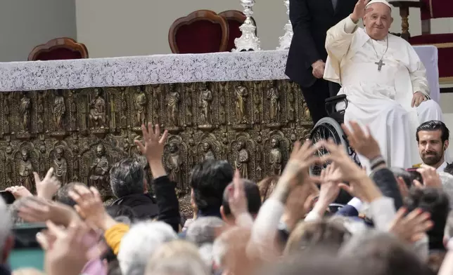 Pope Francis waves to faithful at the end of a mass in St. Mark's Square, Venice, Italy, Sunday, April 28, 2024. The Pontiff arrived for his first-ever visit to the lagoon town including the Vatican pavilion at the 60th Biennal of Arts. (AP Photo/Antonio Calanni)