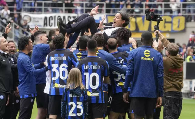 Inter Milan's head coach Simone Inzaghi is thrown in the air by players at the end of a Serie A soccer match between Inter Milan and Torino at the San Siro stadium in Milan, Italy, Sunday, April 28, 2024. Inter Milan had already clinched the Italian Serie A league title the week before. (AP Photo/Luca Bruno)