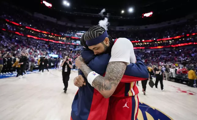 New Orleans Pelicans forward Brandon Ingram, facing, hugs guard Jose Alvarado after defeating the Sacramento Kings in an NBA basketball play-in tournament game in New Orleans, Friday, April 19, 2024. The Pelicans won 105-98. (AP Photo/Gerald Herbert)