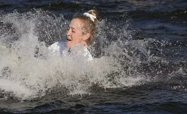 Nelly Korda jumps into the lake after winning the Chevron Championship LPGA golf tournament Sunday, April 21, 2024, at The Club at Carlton Woods in The Woodlands, Texas. (AP Photo/David J. Phillip)