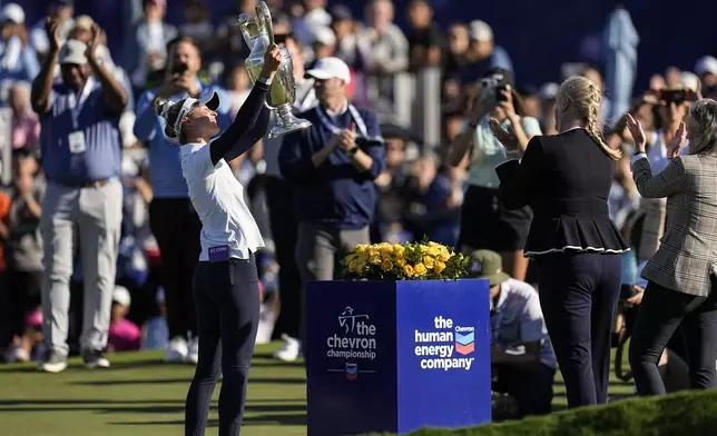 Nelly Korda, left, holds up the trophy after winning the Chevron Championship LPGA golf tournament Sunday, April 21, 2024, at The Club at Carlton Woods in The Woodlands, Texas. (AP Photo/Eric Gay)
