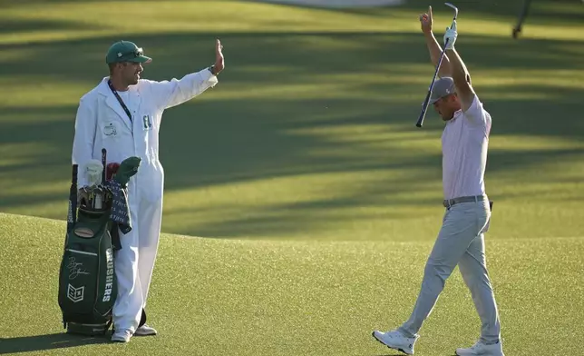 Bryson DeChambeau celebrates after chipping in for a birdie on the 18th hole during third round at the Masters golf tournament at Augusta National Golf Club Saturday, April 13, 2024, in Augusta, Ga. (AP Photo/Ashley Landis)