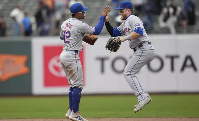 New York Mets' Francisco Lindor, left, celebrates with Harrison Bader after the Mets defeated the San Francisco Giants in a baseball game in San Francisco, Wednesday, April 24, 2024. (AP Photo/Jeff Chiu)