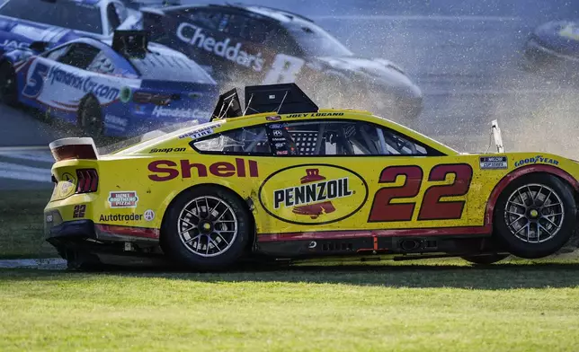 NASCAR Cup Series driver Joey Logano (22) moves during a collision on the final lap of a NASCAR Cup Series auto race at Talladega Superspeedway, Sunday, April 21, 2024, in Talladega. Ala. (AP Photo/Mike Stewart)