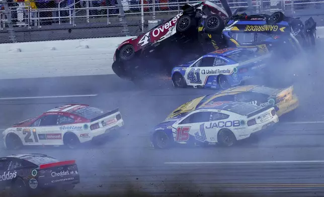 NASCAR Cup Series driver's Ryan Preece (41) Josh Berry (4) and Corey LaJoie (7), upside down, crash on the final lap during a NASCAR Cup Series auto race at Talladega Superspeedway, Sunday, April 21, 2024, in Talladega. Ala. (AP Photo/Butch Dill)