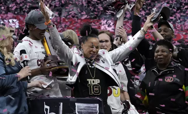 South Carolina head coach Dawn Staley celebrates after the Final Four college basketball championship game against Iowa in the women's NCAA Tournament, Sunday, April 7, 2024, in Cleveland. South Carolina won 87-75. (AP Photo/Morry Gash)