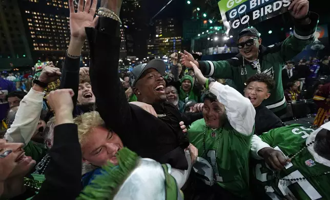 Toledo cornerback Quinyon Mitchell celebrates with fans after being chosen by the Philadelphia Eagles with the 22nd overall pick during the first round of the NFL football draft, Thursday, April 25, 2024, in Detroit. (AP Photo/Paul Sancya)