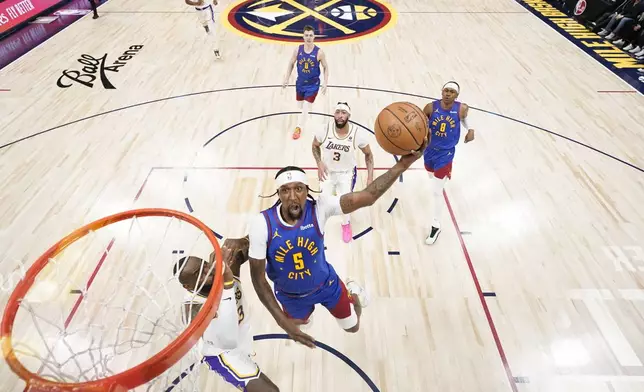 Denver Nuggets guard Kentavious Caldwell-Pope (5) goes up to shoot against Los Angeles Lakers forward LeBron James, left, during the first half in Game 1 of an NBA basketball first-round playoff series, Saturday, April 20, 2024, in Denver. (AP Photo/Jack Dempsey)