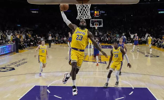 Los Angeles Lakers forward LeBron James (23) dunks during the first half of Game 3 of an NBA basketball first-round playoff series against the Denver Nuggets in Los Angeles, Thursday, April 25, 2024. (AP Photo/Ashley Landis)
