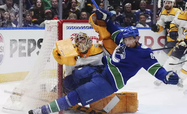 Vancouver Canucks' Dakota Joshua (81) collides with Nashville Predators goalie Juuse Saros during the third period in Game 2 of an NHL hockey Stanley Cup first-round playoff series Tuesday, April 23, 2024, in Vancouver, British Columbia. (Darryl Dyck/The Canadian Press via AP)