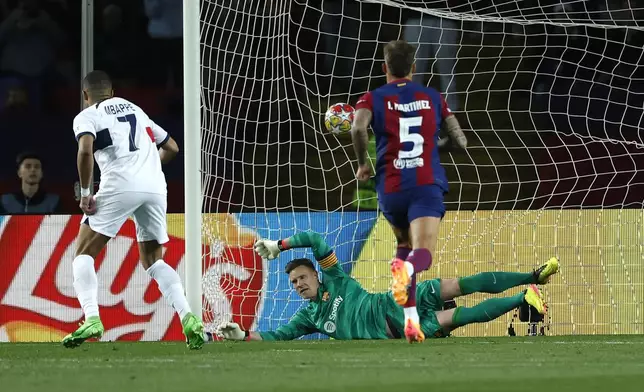 PSG's Kylian Mbappe scores his side's 3rd goal on a penalty kick during the Champions League quarterfinal second leg soccer match between Barcelona and Paris Saint-Germain at the Olimpic Lluis Companys stadium in Barcelona, Spain, Tuesday, April 16, 2024. (AP Photo/Joan Monfort)