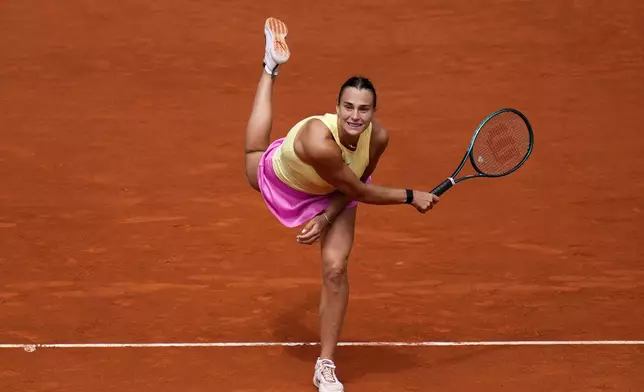 Aryna Sabalenka, of Belarus, returns the ball to Magda Linette, of Poland, during the Mutua Madrid Open tennis tournament in Madrid, Friday, April 26, 2024. (AP Photo/Manu Fernandez)