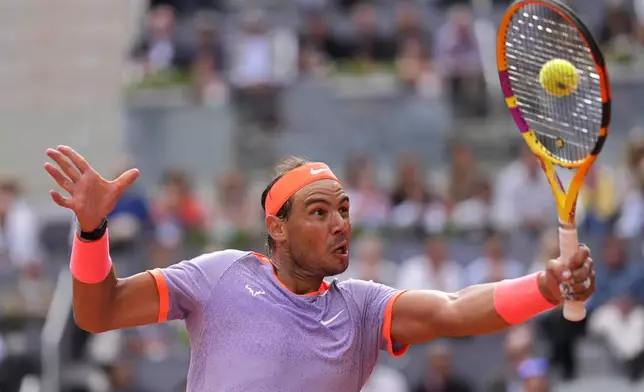 Rafael Nadal of Spain returns the ball to Pedro Cachin of Argentina during the Mutua Madrid Open tennis tournament in Madrid, Spain, Monday, April 29, 2024. (AP Photo/Manu Fernandez)