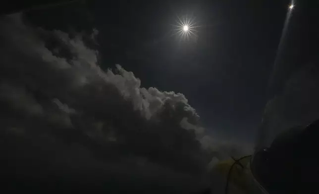 A nighttime sky unfolds in the afternoon as the moon partially covers the sun during a total solar eclipse, as seen from the air in a Cessna 172 aircraft, at about 5,000 ft., over in Arkadelphia, Ark., within the path of totality, Monday, April 8, 2024. (AP Photo/Gerald Herbert)