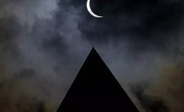 The moon is seen passing in front of the sun with the top of the Washington Monument in silhouette during a solar eclipse in Washington on Monday, April 8, 2024. (Bill Ingalls/NASA via AP)
