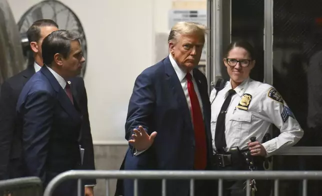 Former President Donald Trump gives a thumbs up as he returns to the courtroom after a break during the first day of his trial at Manhattan Criminal Court in New York, on Monday, April 15, 2024. Trump's hush money trial begins Monday with jury selection. It's a singular moment for American history as the first criminal trial of a former U.S. commander in chief. (Angela Weiss/Pool Photo via AP)