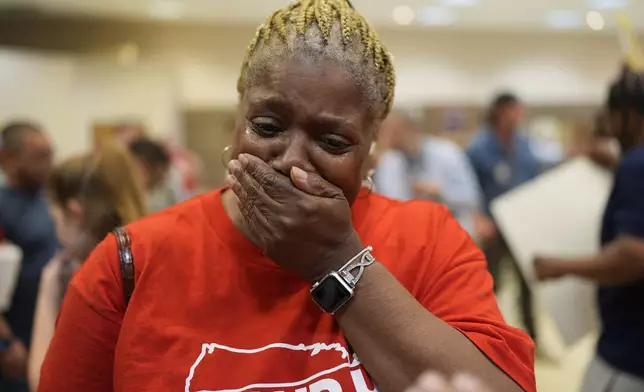 Volkswagen automobile plant employee Vicky Holloway becomes emotional as she celebrates after employees voted to join the UAW union Friday, April 19, 2024, in Chattanooga, Tenn. (AP Photo/George Walker IV)