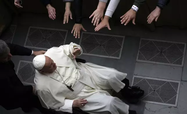 Pope Francis arrives for an audience with pilgrims coming from various Italian dioceses on the occasion of the bicentenary of the death of Pope Pius VII, in the Paul VI Hall, at the Vatican, Saturday, April 20, 2024. (AP Photo/Alessandra Tarantino)