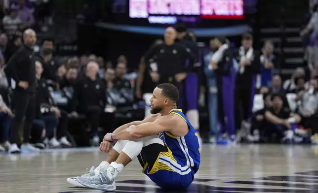Golden State Warriors guard Stephen Curry sits on the court during the second half of the team's NBA basketball play-in tournament game against the Sacramento Kings, Tuesday, April 16, 2024, in Sacramento, Calif. (AP Photo/Godofredo A. Vásquez)