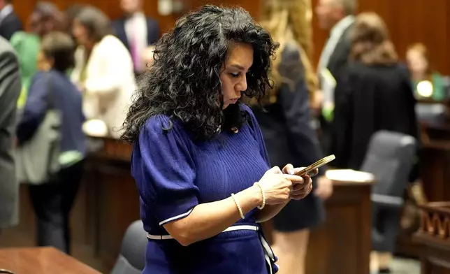 Arizona State Rep. Teresa Martinez, R, texts on House floor at the Capitol, Wednesday, April 10, 2024, in Phoenix. The Arizona Supreme Court ruled Tuesday that the state can enforce its long-dormant law criminalizing all abortions except when a mother's life is at stake. (AP Photo/Matt York)