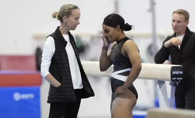 Gabby Douglas, center, talks with Anna Kotchneva during a break in competition at the American Classic Saturday, April 27, 2024, in Katy, Texas. (AP Photo/David J. Phillip)