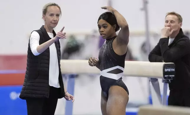 Gabby Douglas, right, talks with Anna Kotchneva during a break in competition at the American Classic Saturday, April 27, 2024, in Katy, Texas. (AP Photo/David J. Phillip)