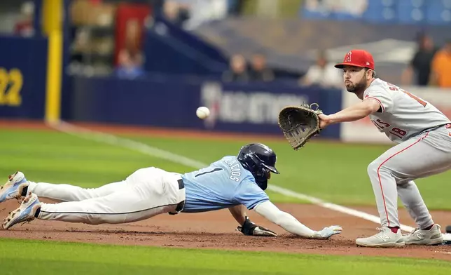 Tampa Bay Rays' Richie Palacios (1) dives back safely ahead of the pickoff throw to Los Angeles Angels first baseman Nolan Schanuel during the first inning of a baseball game Thursday, April 18, 2024, in St. Petersburg, Fla. (AP Photo/Chris O'Meara)
