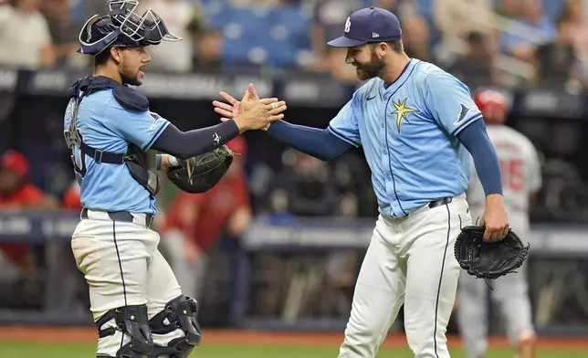 Tampa Bay Rays relief pitcher Colin Poche, right, celebrates with catcher Rene Pinto after closing out the Los Angeles Angels during a baseball game Thursday, April 18, 2024, in St. Petersburg, Fla. The Rays beat the Angels 2-1. (AP Photo/Chris O'Meara)