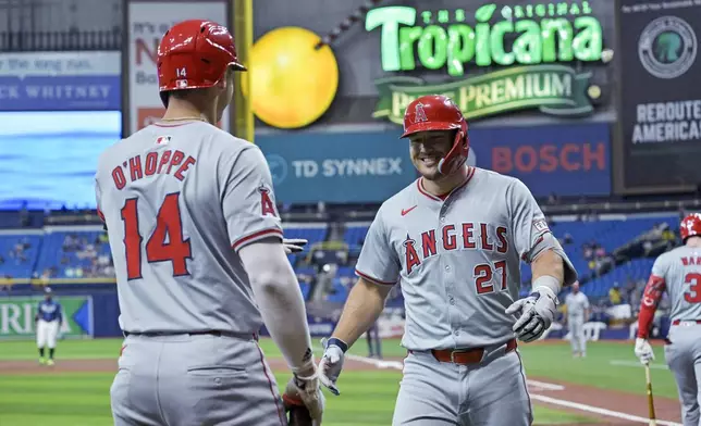 Los Angeles Angels' Logan O'Hoppe (14) greets Mike Trout (27) after Trout's solo home run off Tampa Bay Rays starter Zack Littell during the first inning of a baseball game Wednesday, April 17, 2024, in St. Petersburg, Fla. (AP Photo/Steve Nesius)