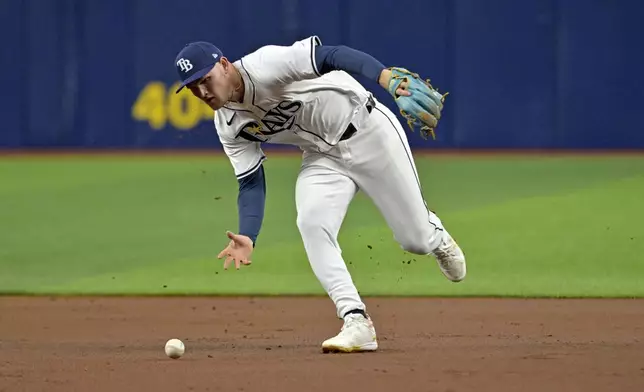 Tampa Bay Rays second baseman Curtis Mead reaches for a ground ball single hit by Los Angeles Angels' Jo Adell during the second inning of a baseball game Monday, April 15, 2024, in St. Petersburg, Fla. (AP Photo/Steve Nesius)