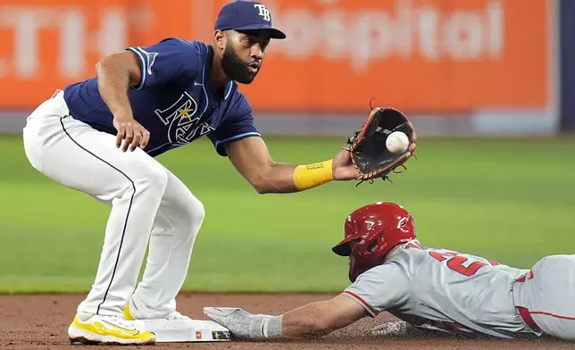 Los Angeles Angels' Mike Trout (27) steals second base ahead of the throw to Tampa Bay Rays' Amed Rosario during the first inning of a baseball game Tuesday, April 16, 2024, in St. Petersburg, Fla. (AP Photo/Chris O'Meara)
