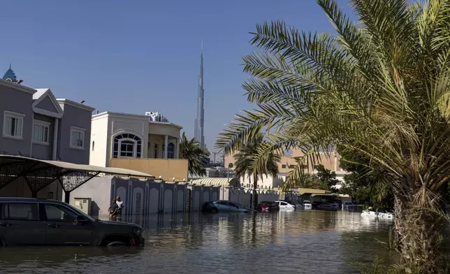 A flooded street by heavy rain is seen, with the Burj Khalifa, the world's tallest building, on the background, in Dubai, United Arab Emirates, Thursday, April 18, 2024. The United Arab Emirates attempted to dry out Thursday from the heaviest rain the desert nation has ever recorded, a deluge that flooded out Dubai International Airport and disrupted flights through the world's busiest airfield for international travel. (AP Photo/Christopher Pike)