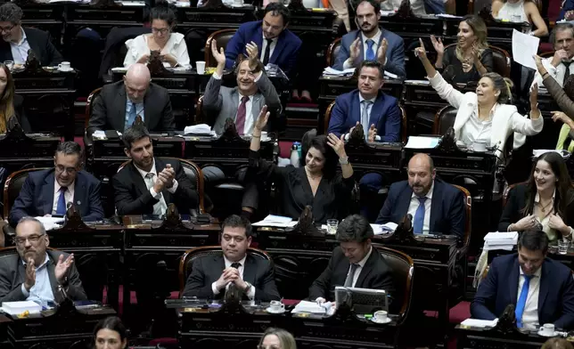 Lawmakers celebrate after approving part of a bill promoted by Argentine President Javier Milei in Buenos Aires, Argentina, Tuesday, April 30, 2024. Congress' lower house is debating a bill promoted by Argentine President Javier Milei that includes a broad range of economic, administrative, criminal, and environmental reforms. (AP Photo/Natacha Pisarenko)