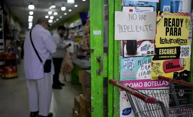 A piece of paper with a message that reads in Spanish: "There is no repellent" is taped to a storefront in Buenos Aires, Argentina, Thursday, April 4, 2024. An increase in dengue fever cases as resulted in the demand for repellents to avoid the bite of the mosquito that transmits the disease, causing a shortage and exorbitant prices where available. (AP Photo/Natacha Pisarenko)
