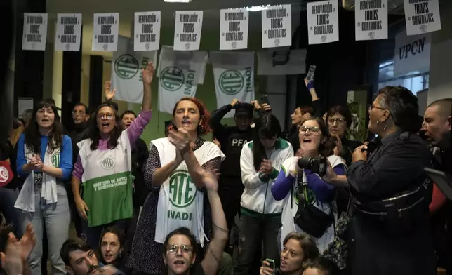 State workers, some who have been laid off, protest against the dismissal of state employees, inside the National Institute against Discrimination, Xenophobia, and Racism in Buenos Aires, Argentina, Wednesday, April 3, 2024. According to the State Workers Association, more than 11 thousand dismissals of state employees have been carried out by Javier Milei’s government. (AP Photo/Natacha Pisarenko)