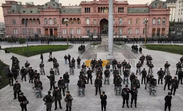 Police guard the Casa Rosada presidential palace during a march demanding more funding for public universities and to protest against austerity measures proposed by President Javier Milei, in Buenos Aires, Argentina, Tuesday, April 23, 2024. (AP Photo/Rodrigo Abd)
