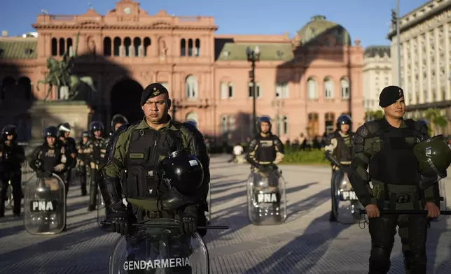Police guard the Casa Rosada presidential palace during a march demanding more funding for public universities and to protest against austerity measures proposed by President Javier Milei, in Buenos Aires, Argentina, Tuesday, April 23, 2024. (AP Photo/Natacha Pisarenko)