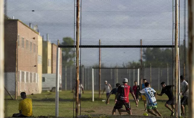 Inmates play soccer at Pinero jail in Pinero, Argentina, Tuesday, April 9, 2024. Authorities have ramped up prison raids, seized thousands of smuggled cellphones and restricted visits. (AP Photo/Natacha Pisarenko)
