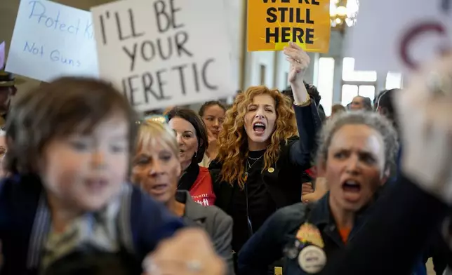 People protest outside the House chamber after legislation passed that would allow some teachers to be armed in schools during a legislative session Tuesday, April 23, 2024, in Nashville, Tenn. (AP Photo/George Walker IV)